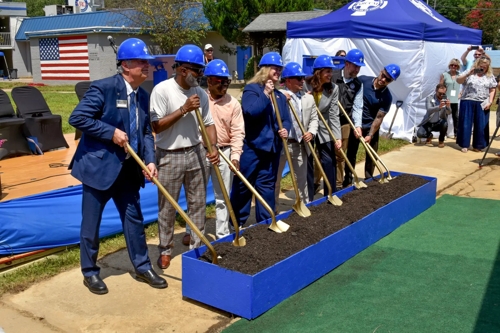Officials in hard hats with gold shovels at the groundbreaking for the new Veterans Restoration Quarters in Asheville.