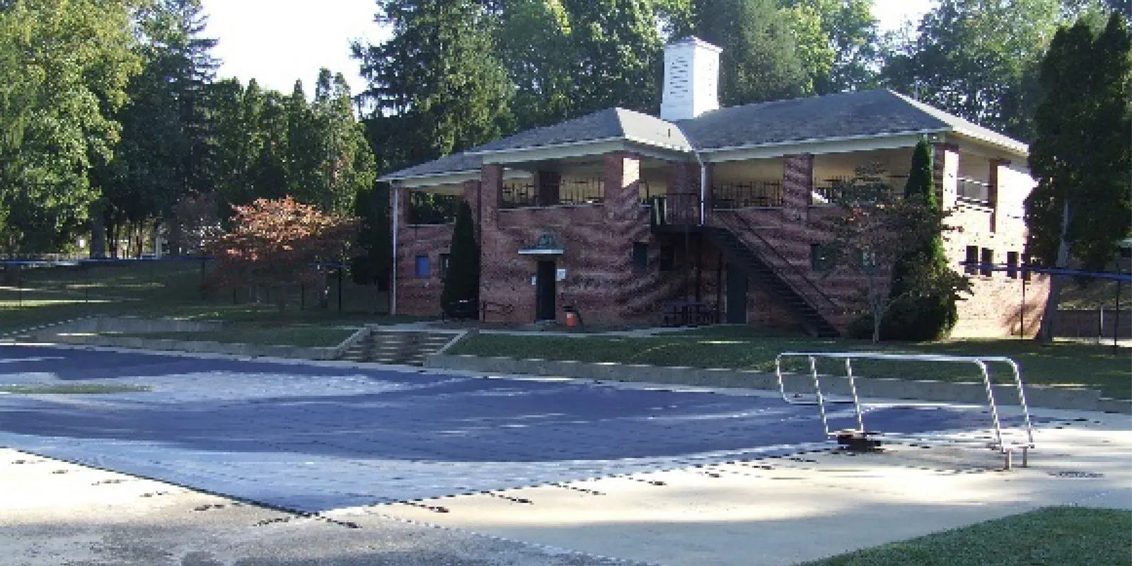 The pool and brick bathhouse at Malvern Hills Park (City alt text: "pool house at malvern hills pool")